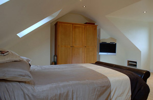 Bed and TV in loft conversion