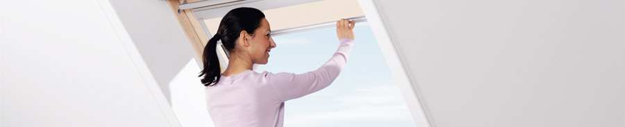 Woman opening loft conversion window